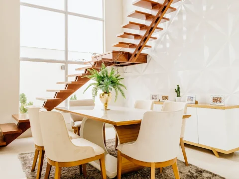 A nice dining area with furniture consisting of wood and white elements