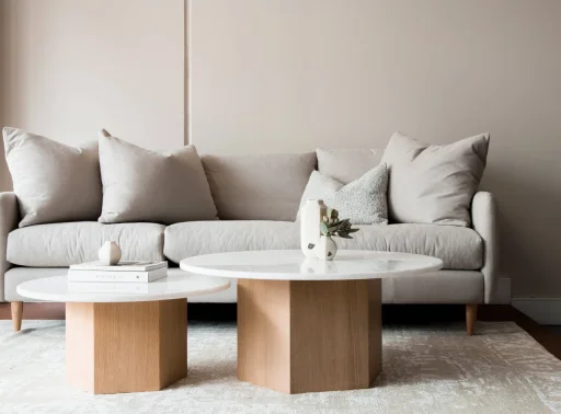 A stylish grey couch with two small tables